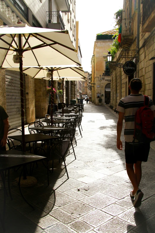 people are walking on an open city sidewalk