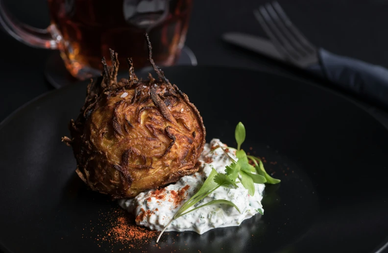 a plate with a baked potato on top of whipped cream