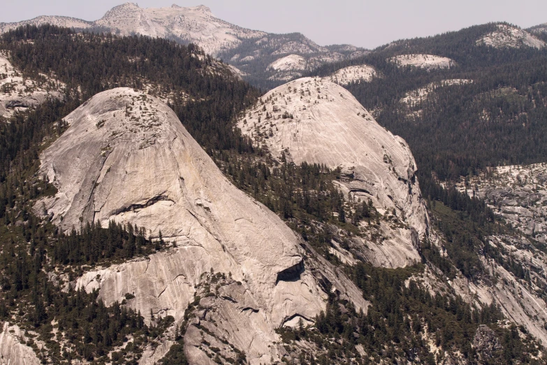 a couple of large rocks that have trees on them