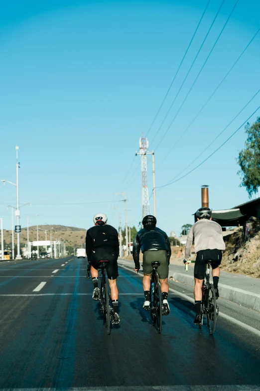 two bicyclists riding in a street between two lanes