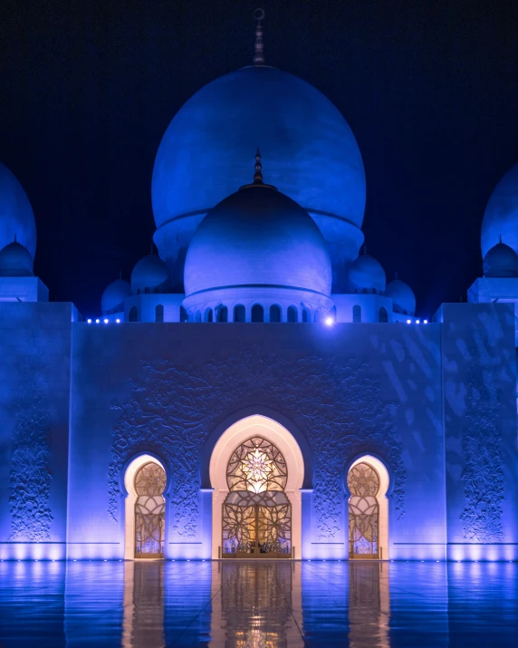 an illuminated building and pillars is shown in this pograph