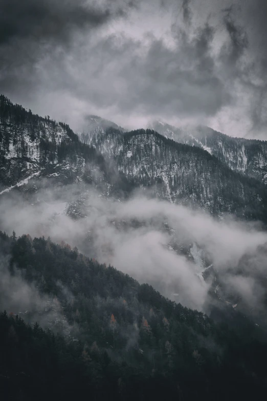 a cloudy valley filled with lush green hills