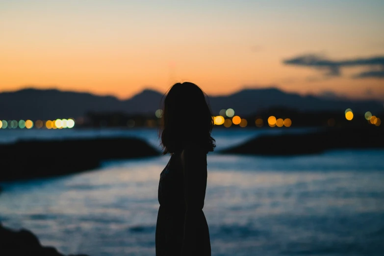 silhouette po of a girl on the side of water