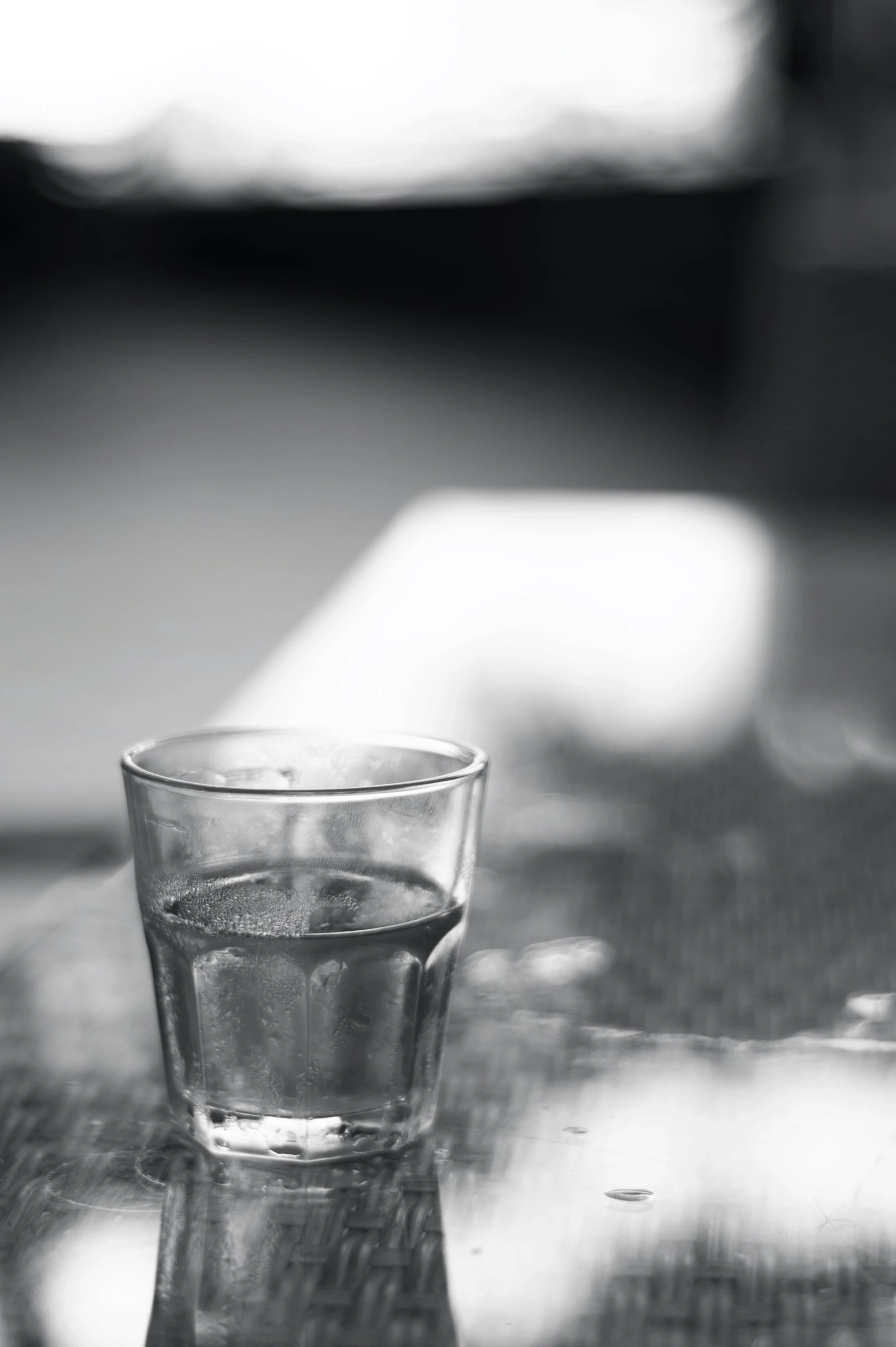 a glass sitting on a table with a spoon on it