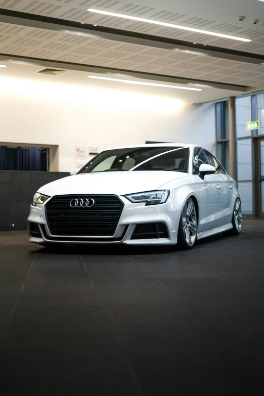 a white car is parked inside a garage