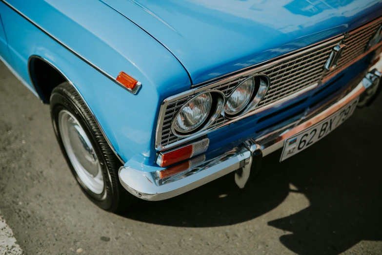 blue car in parking lot on sunny day