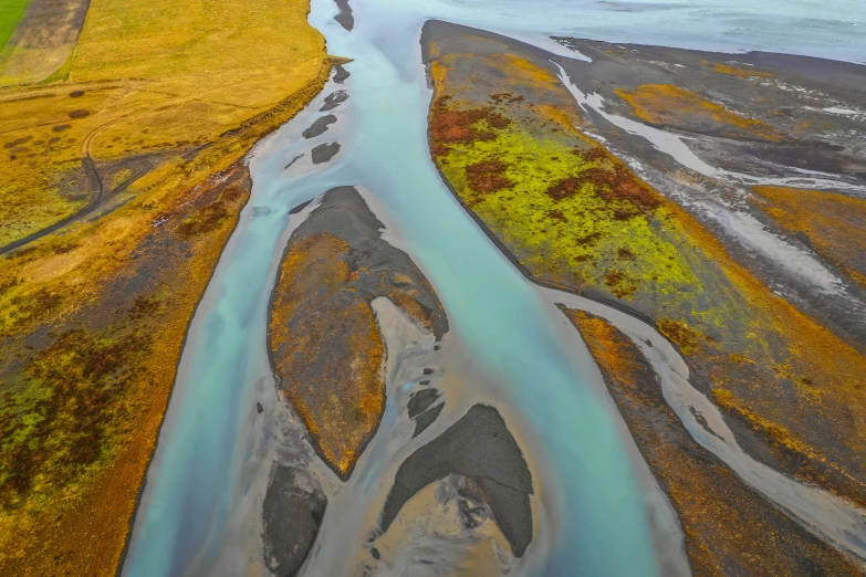 a wide river running through a dry grassy landscape