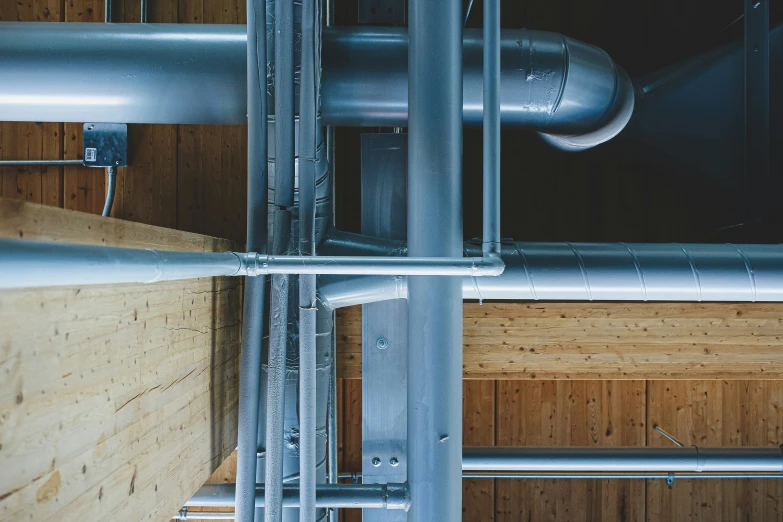 view of metal pipes and a wooden wall