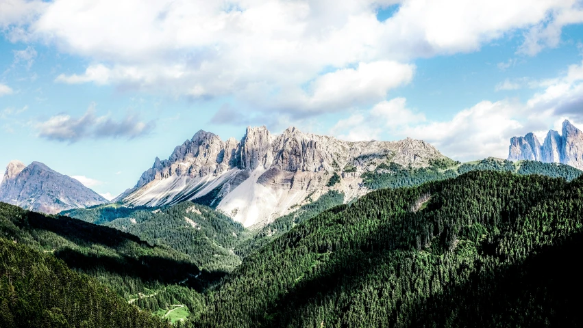 mountains with clouds on a blue sky day