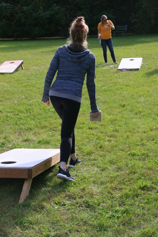 two girls are playing with their boards in the yard