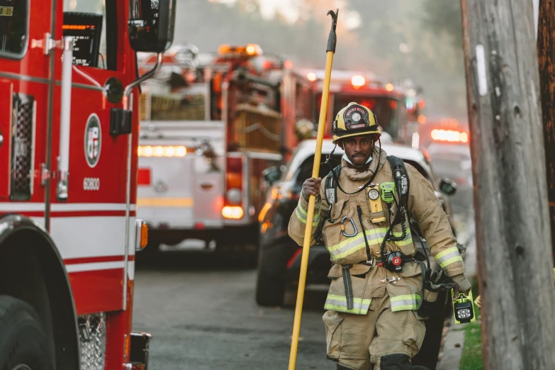 the firefighter is walking away from the truck