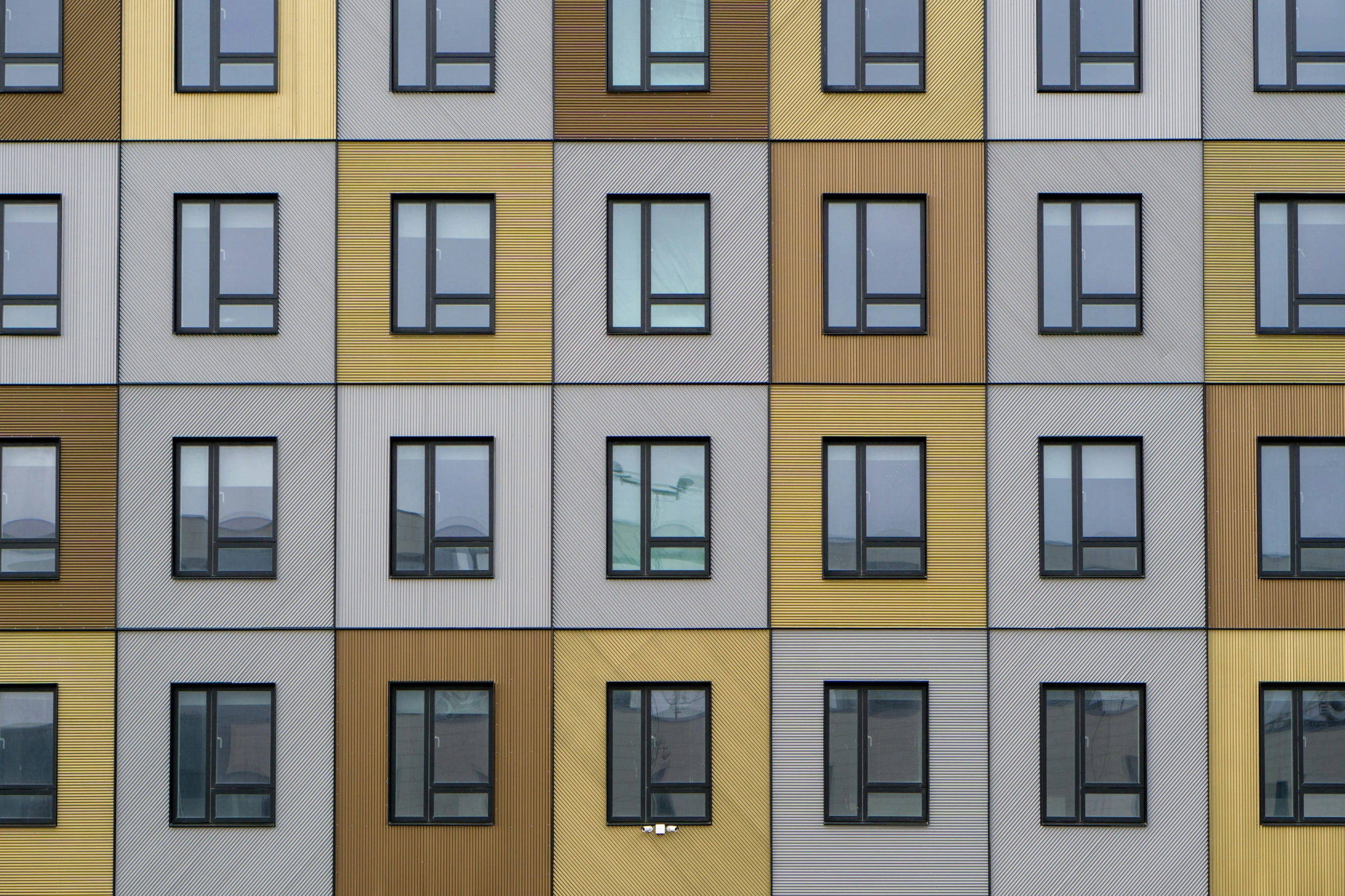 a very tall multicolored building with lots of windows