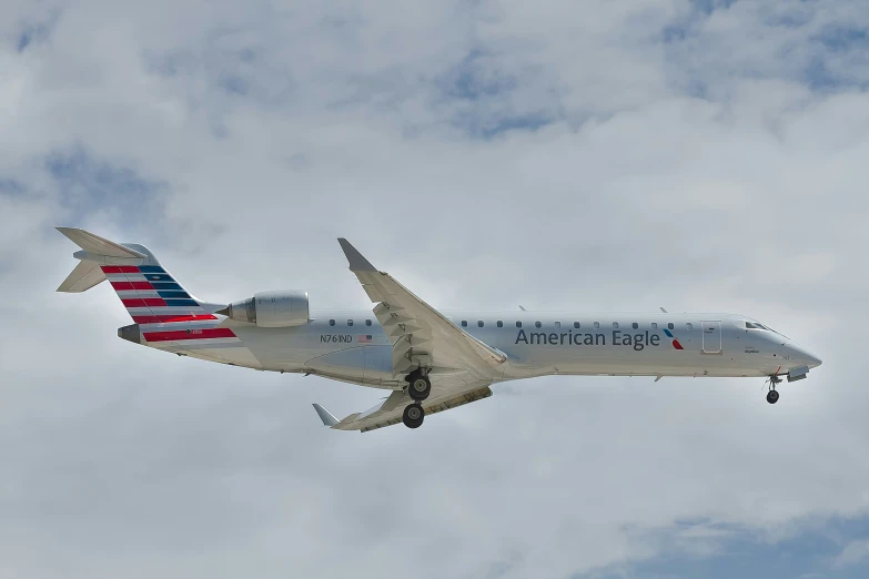 an american eagle jet flying through a cloudy sky