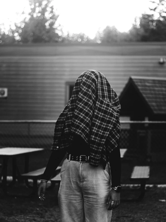 an old man stands in front of a train