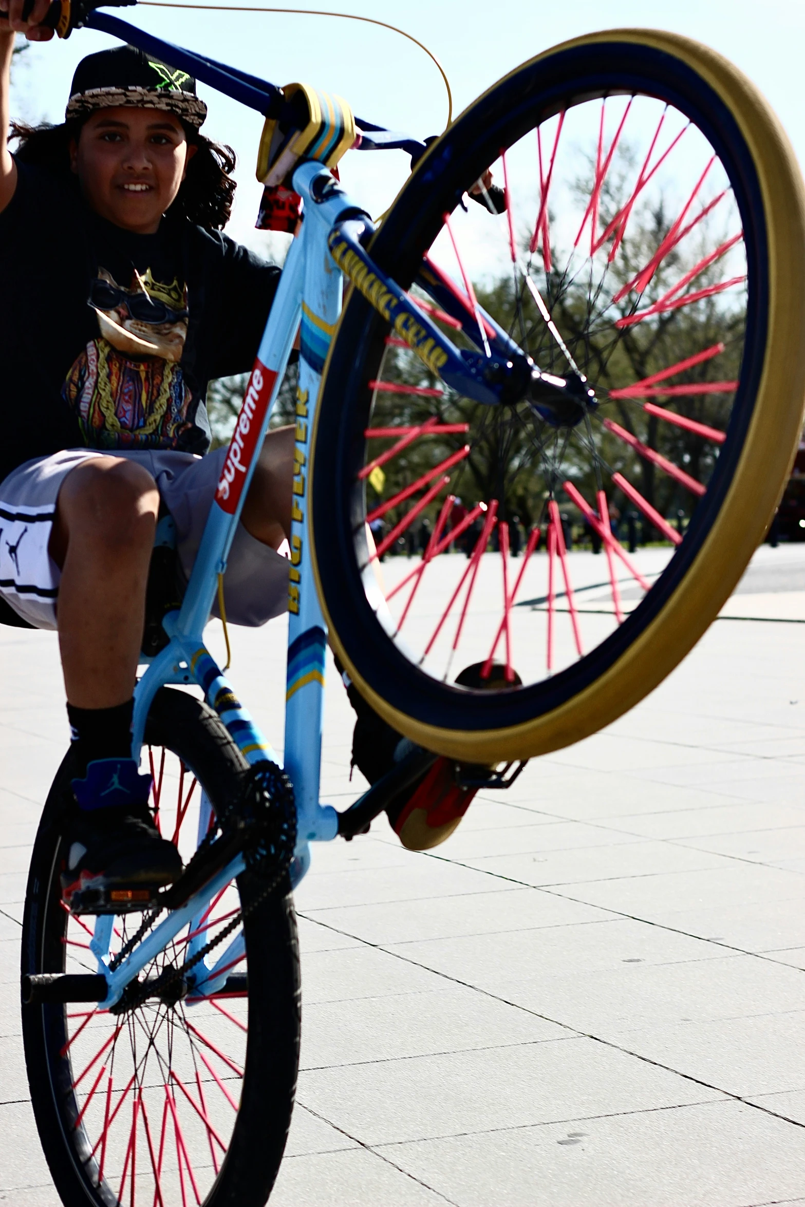 the boy is sitting on his bike, and he has just jumped