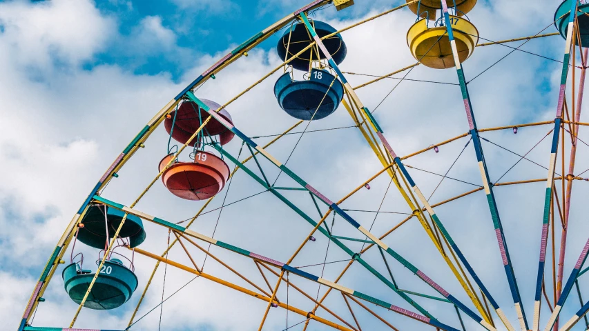 there is a colorful ferris wheel with lots of hanging pots