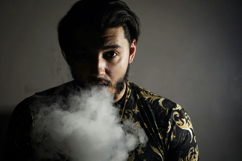 a man standing behind clouds of smoke near his mouth