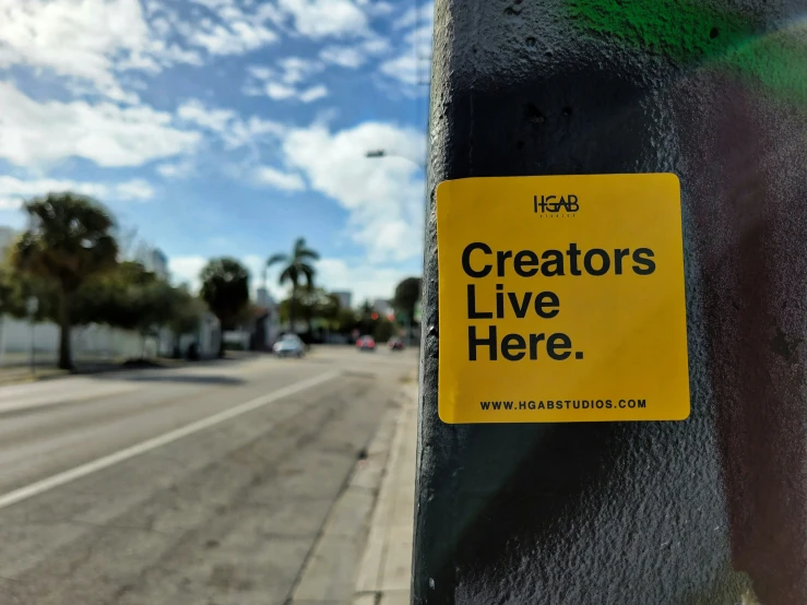 a sticker on a pole that reads creators live here