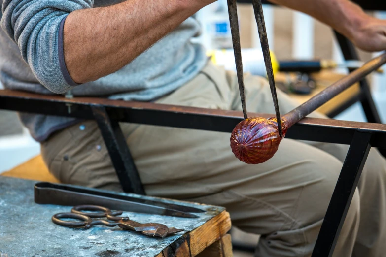 an elderly man with some scissors on a table