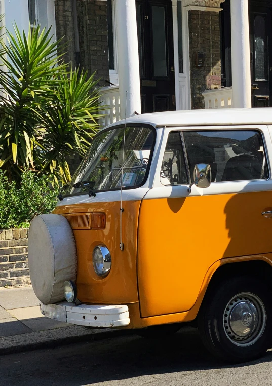 an old vw bus parked next to a building