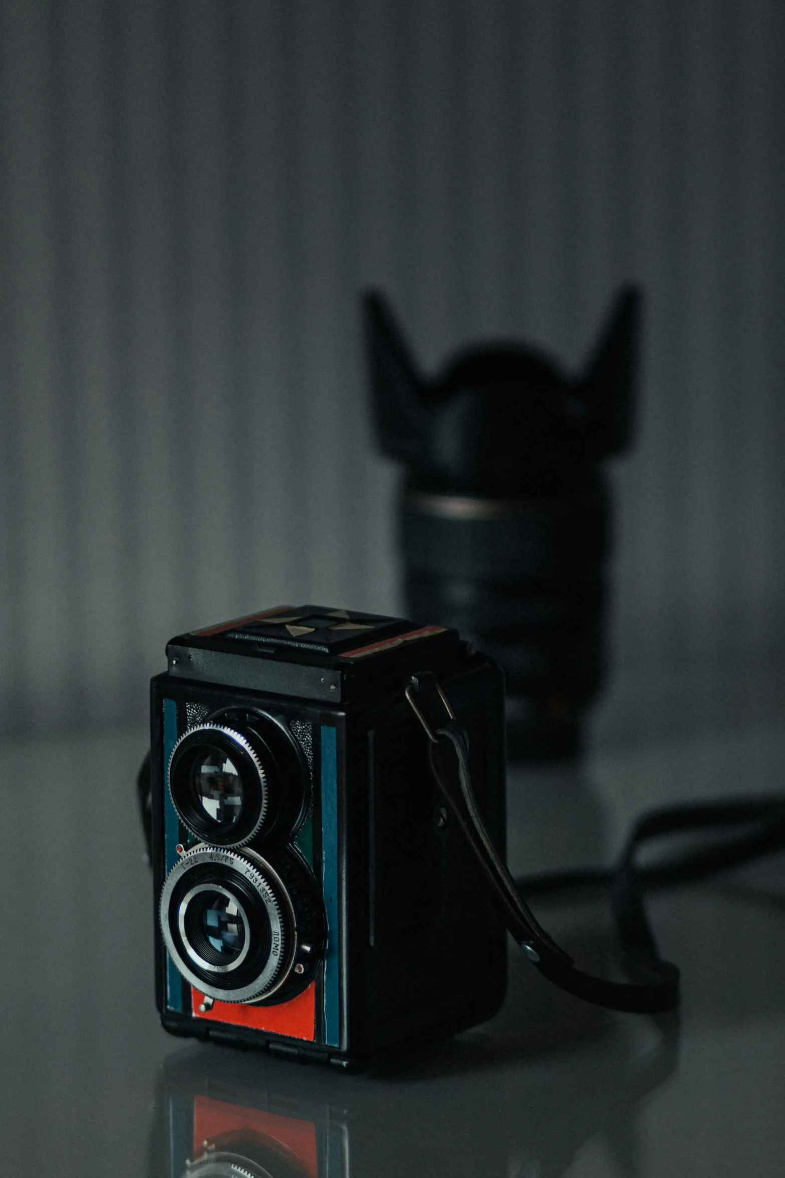 an old camera on a glass table