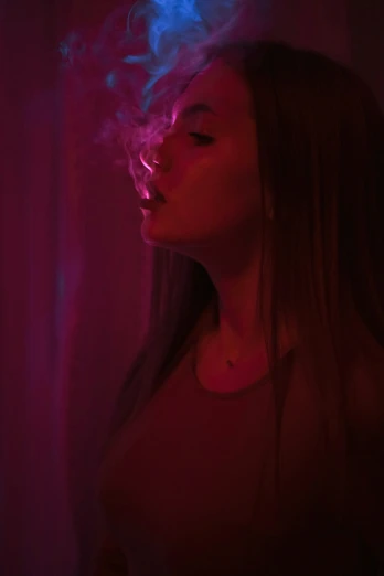 the girl is smoking soing in the dark
