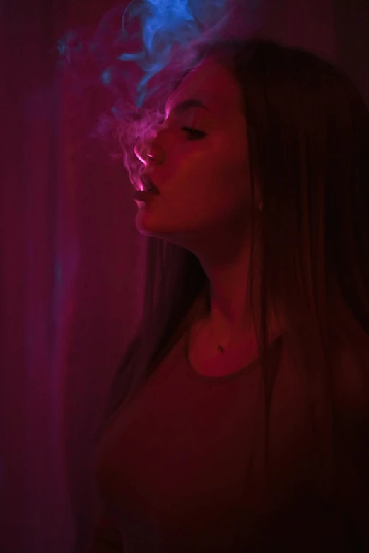 the girl is smoking soing in the dark