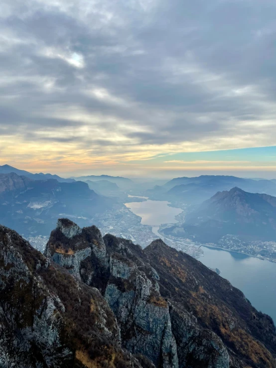 a person standing on top of a mountain on a cellphone