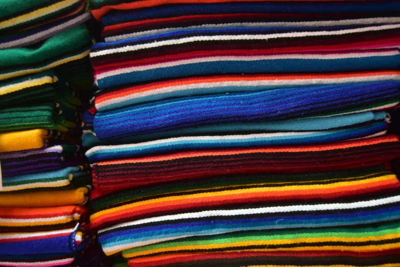 a stack of colorful knits is shown on display