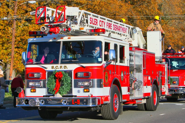 there are many red and white fire trucks on the street