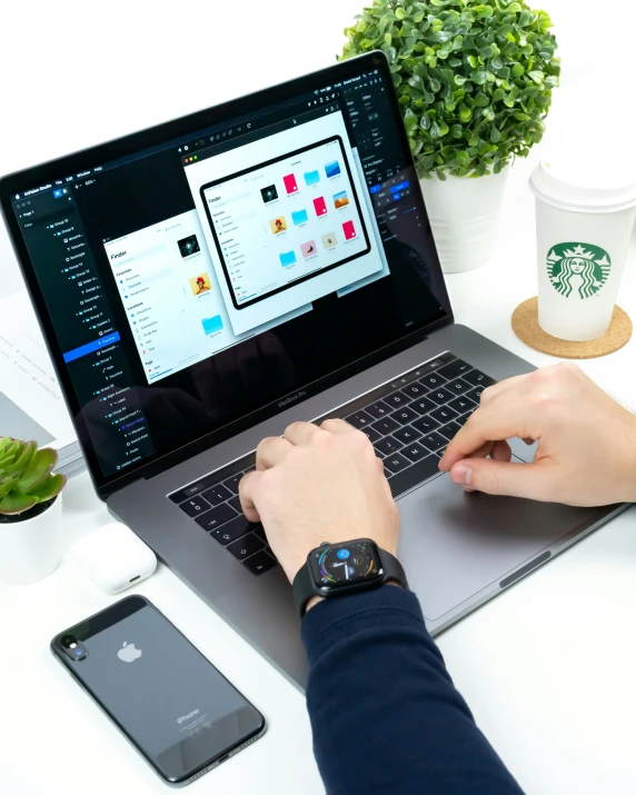 a person working on their laptop at a desk