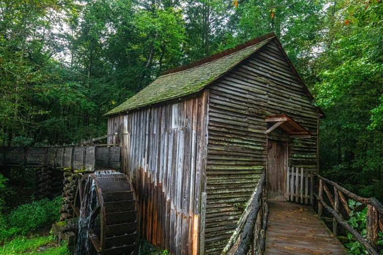 a grist mill located on the side of a country road