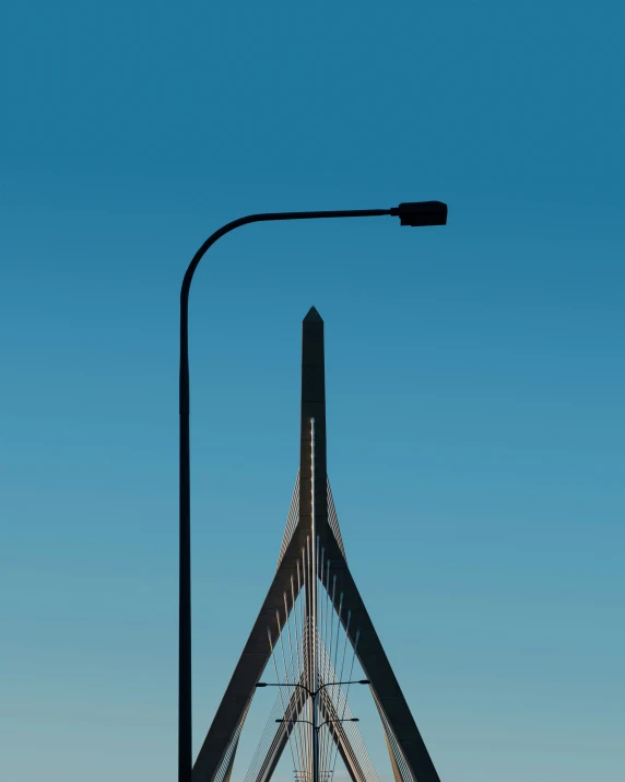 a view looking up at the top of a tower under a street lamp