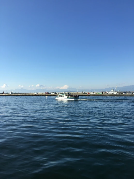 a large body of water sitting under a blue sky