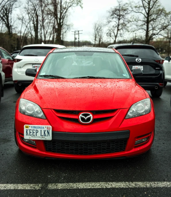 a car parked in a lot next to others cars