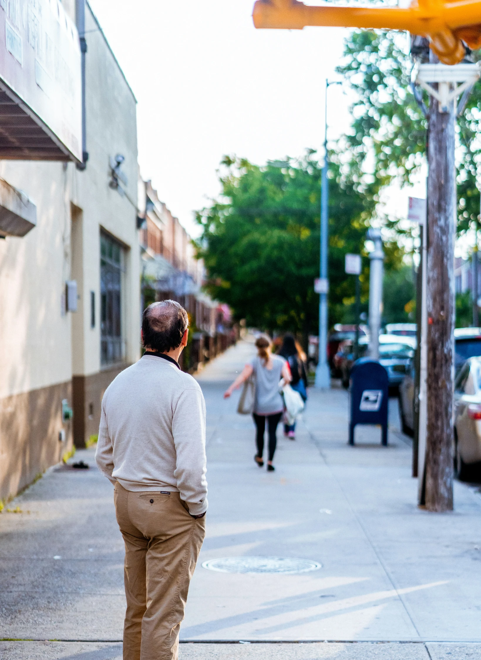 a man standing on the side of the road in front of a building