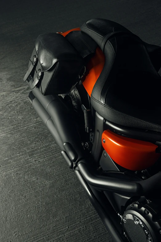 the back seats of a motorcycle are in black and orange