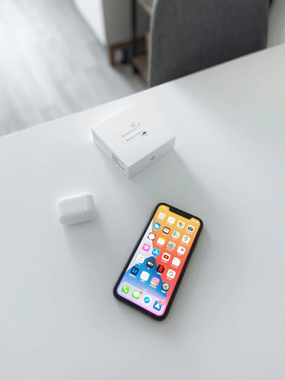 an iphone on the desk next to a controller