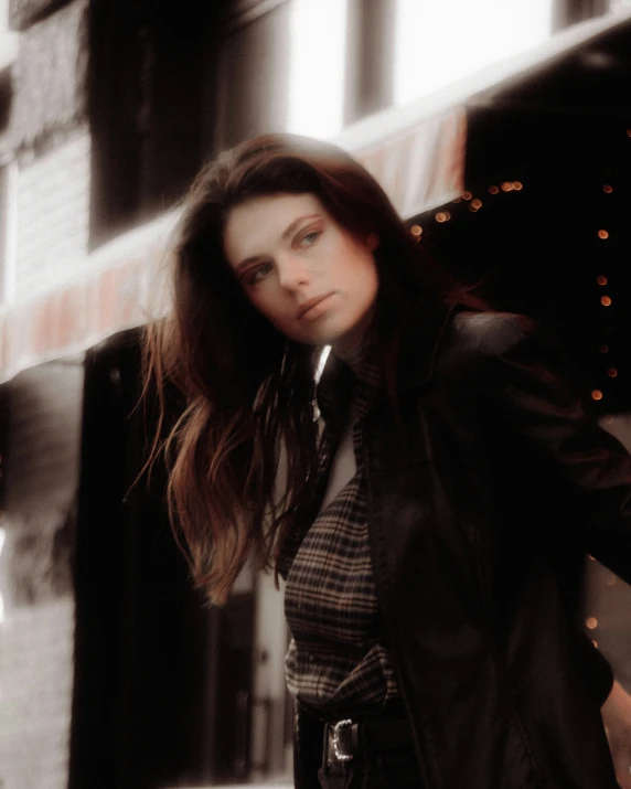 a beautiful woman standing on top of a city street