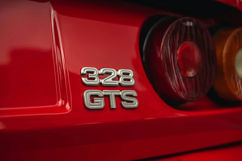 a close up of the front end of a red sports car