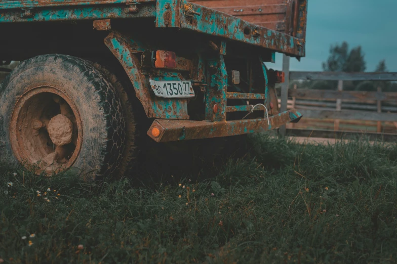 a close up of the side end of an old rusty looking truck with a sign on it's front