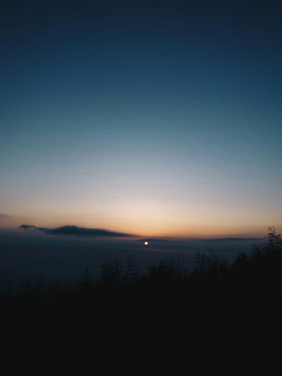 a view from a hill at sunset