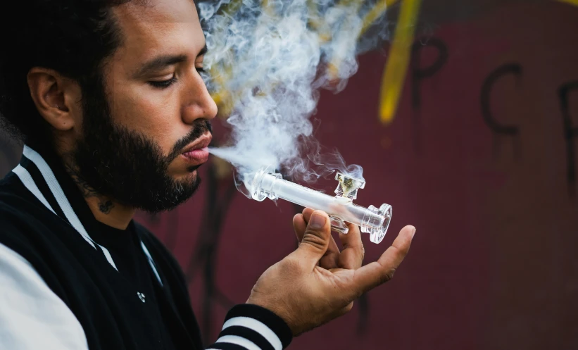 a man lighting on a cigarette in a smoker