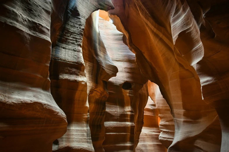 the man is climbing down a canyon in a rock