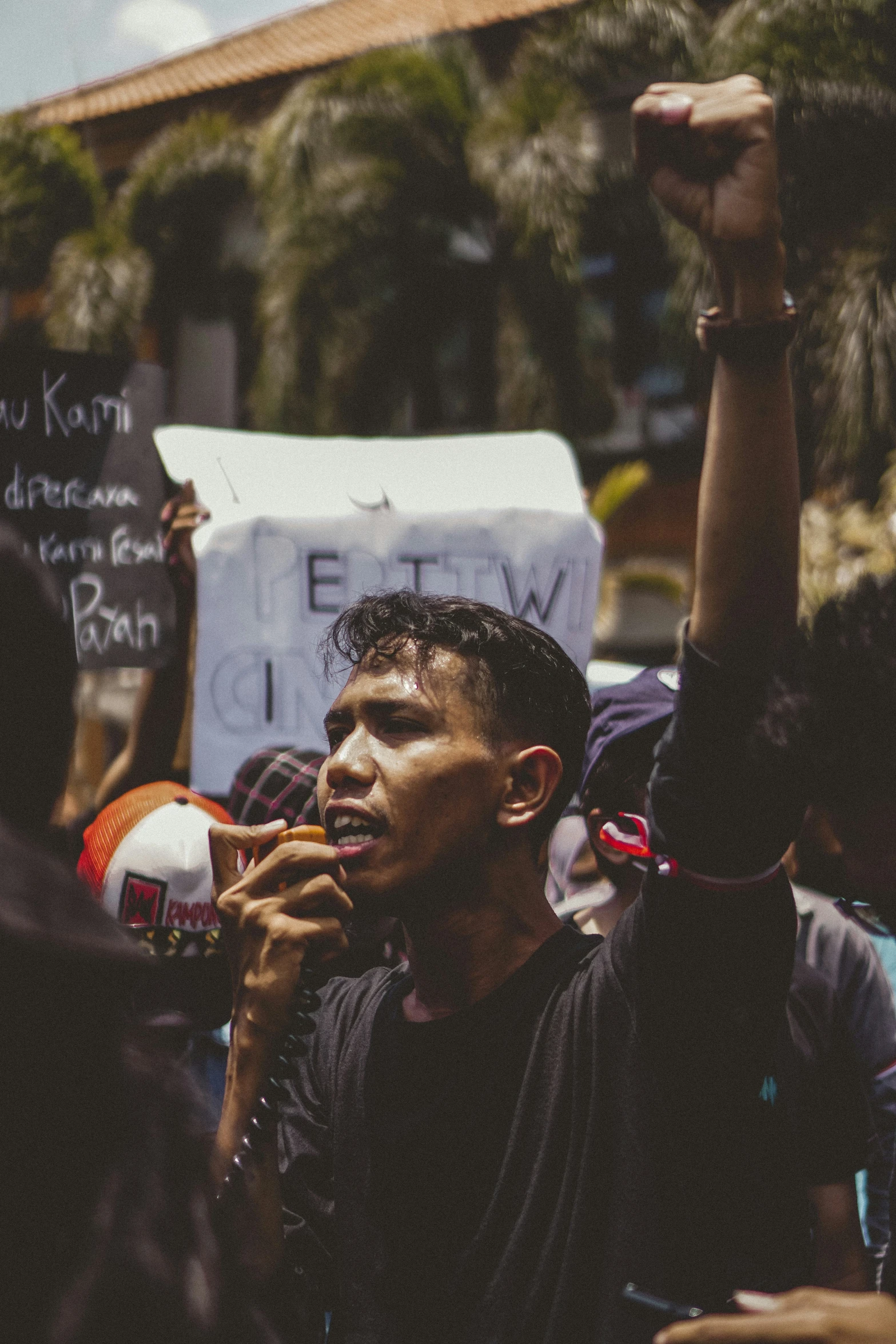 a man holding up a wine glass in front of a crowd of people