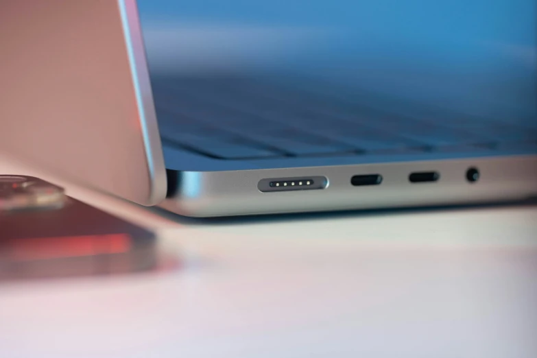 an electronic mouse laying next to an opened lap top