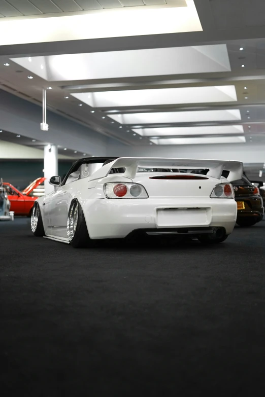 several different colored and white car sitting on the floor