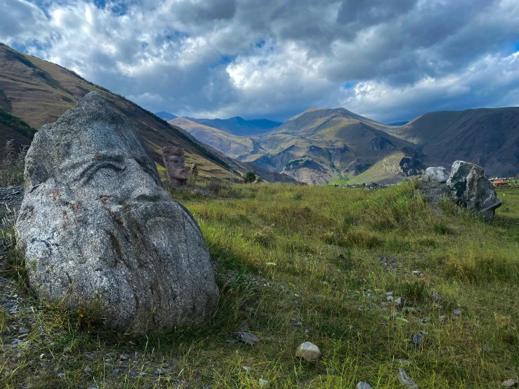 there is a rock that is in the middle of a field