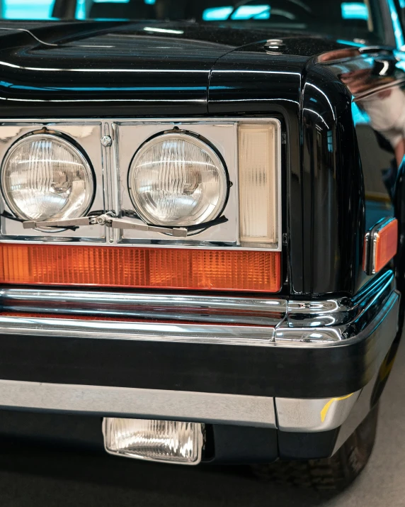 the front end of an automobile with its light on