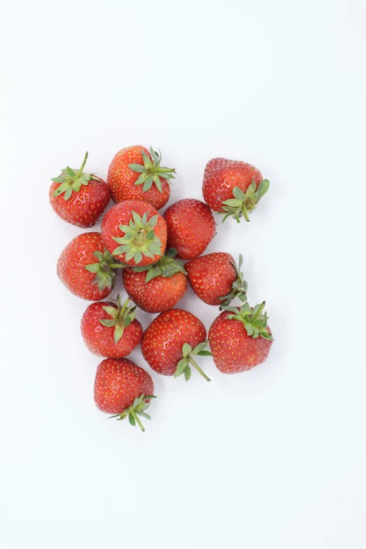 five strawberries are arranged in a pile